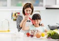 mother and child in kitchen preparing cookies