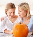 Happy, mother and child with pumpkin to celebrate halloween, party and fun together at home. Young girl, mom and family Royalty Free Stock Photo