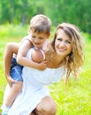 Happy mother with child son having fun outdoors in summer Royalty Free Stock Photo