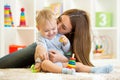 Happy mother and child son playing indoor at home Royalty Free Stock Photo