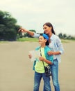 Happy mother with child son tourists sightseeing city with paper map Royalty Free Stock Photo