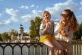 Happy mother and child tourists eating traditional Spain churro