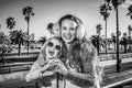 Happy mother and child tourists showing heart shaped hands