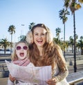 Happy mother and child travellers in Barcelona, Spain with map Royalty Free Stock Photo