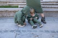 Happy mother with children in fashionable clothes family look in a park Royalty Free Stock Photo