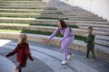 Happy mother with children in fashionable clothes family look in a park Royalty Free Stock Photo