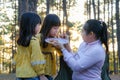 Happy mother and children picnic sit by stove near tent and grill a barbecue in pine forest, eating and have conversation. Happy