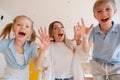 Happy mother with children, small son and daughter running towards