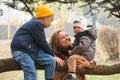 Happy mother and children at walk in park. Happy family playing outdoors in cold weather. Family, motherhood, people and vacation Royalty Free Stock Photo
