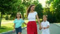 Happy mother with children walking in park. Family meeting father outdoors Royalty Free Stock Photo