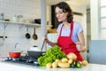 Happy mother cooking for children at kitchen