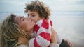 Happy mother cuddling son at autumn ocean shore closeup. Sincere family emotions Royalty Free Stock Photo