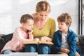 happy mother with cute little kids sitting Royalty Free Stock Photo