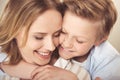 Happy mother and cute little son hugging together at home Royalty Free Stock Photo