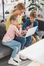 happy mother with cute smiling children using laptop together Royalty Free Stock Photo