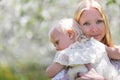 Peaceful Mother Holding Baby Outside in Flowering Apple Orchard Royalty Free Stock Photo