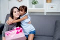 happy of mother and daughter asian with gift with pink ribbon and daughter.