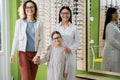 happy mother, daughter and asian oculist