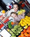 Happy mother and daughter buying ripe fruits Royalty Free Stock Photo