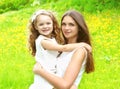 Happy mother and daughter child hugging in summer Royalty Free Stock Photo