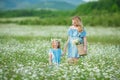 Happy mother and daughter child together with yellow dandelion flowers in summer day enjoy vacation free time together happy Royalty Free Stock Photo