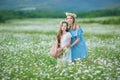 Happy mother and daughter child together with yellow dandelion flowers in summer day enjoy vacation free time together happy Royalty Free Stock Photo