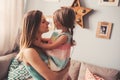 Happy mother and daughter having fun at home