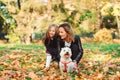 Happy mother and daughter having fun together with theirs dog Royalty Free Stock Photo