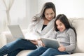 Happy mother and daughter with laptop and tablet pc Royalty Free Stock Photo