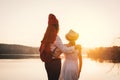 Happy mother and daughter looking at the sky during sunset