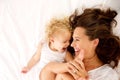 Happy mother and daughter lying on bed Royalty Free Stock Photo