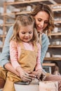 happy mother and daughter making ceramic pot Royalty Free Stock Photo