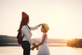 Happy mother and daughter in nature during sunset