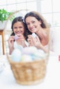 Happy mother and daughter painting easter eggs Royalty Free Stock Photo