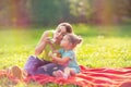 Mother and daughter in the park blows soup foam and make bubbles