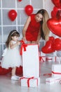 Happy mother and daughter parses gifts on Valentine`s Day Royalty Free Stock Photo