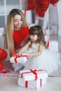 Happy mother and daughter parses gifts on Valentine`s Day Royalty Free Stock Photo