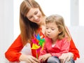 Happy mother and daughter with pinwheel toy Royalty Free Stock Photo