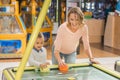 happy mother and daughter playing air hockey together