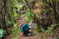 Happy mother and daughter posing on a forest path.