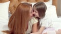 Happy mother and daughter rubbing noses, resting at home together Royalty Free Stock Photo