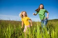 Happy mother and daughter run on field Royalty Free Stock Photo