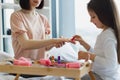 Happy mother and daughter sitting in bed at home and doing manicure. Royalty Free Stock Photo