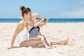 Happy mother and daughter in swimsuits taking photos at beach Royalty Free Stock Photo