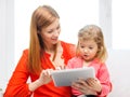 Happy mother and daughter with tablet pc computer Royalty Free Stock Photo