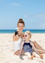 Happy mother and daughter taking selfies with camera at beach Royalty Free Stock Photo