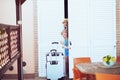 Happy mother and daughter tourists looking out from hotel door Royalty Free Stock Photo