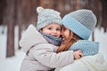 Happy mother and daughter on the walk in snowy winter Royalty Free Stock Photo