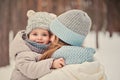 Happy mother and daughter on the walk in snowy winter Royalty Free Stock Photo