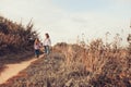 Happy mother and daughter on the walk on summer field. Family spending vacation outdoor Royalty Free Stock Photo